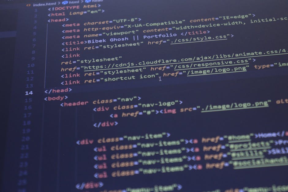 A photograph of a computer screen displaying lines of HTML code in various colors including yellow, blue, red, and white. The code contains tags and attributes for web development, with visible sectio